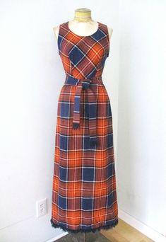 Lovely vintage 1960's or 70's navy blue and orange plaid maxi dress from Donnkenny. Medium weight flannel, washable so it's likely acrylic, feels kinda like wool though. Features - tie sash belt with fringe - blanket style fringe at hem - center back zip - unlined APPROXIMATE MEASUREMENTS in inches - lying flat Size:  Unknown, likely Small  Chest, armpit to armpit:  17 Waist:  12.5 Hips:  17 Length, from shoulder:  54 CONDITION Very good to excellent vintage conditi Blanket Fringe, Plaid Maxi Dress, Fringe Blanket, 1970s Dresses, Orange Plaid, Sash Belts, Sash Belt, Small Chest, Tartan Plaid