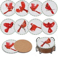 six coasters with red birds on them and a cork coaster holder in the middle