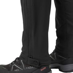 the legs and feet of a person wearing black snow boots with zippers on them