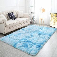 a living room filled with furniture and a blue rug