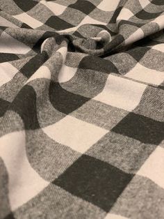 a black and white checkered blanket laying on top of a bed