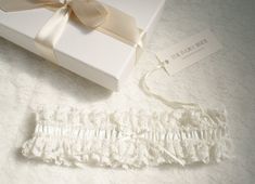 The romantic Classic Garter, made from soft Ivory satin which is trimmed with Ivory lace and decorated in clear beads and pearl detailing, finished with a Ivory satin hand tied bow Every garter Is handcrafted here In England, all fabric and lace is hand cut, all embellishments and decoration and each bead is carefully hand sewn on to give a complete authentic handcrafted product. Each Garter is presented In a quality keepsake gift box finished with a luxurious satin ribbon bow, your garter will Pearl Garter, Ivory Bride, Romantic Classic, Satin Hands, Satin Ribbon Bow, Lace Garter, Pearl And Lace, Bridal Garter, Wedding Garter