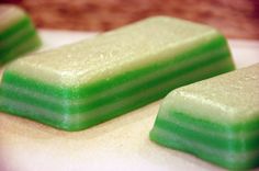 three green and white candy bars sitting on top of a counter next to each other