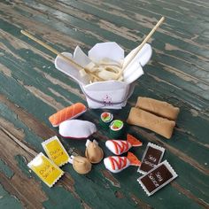 sushi and chopsticks on a wooden table next to an ice cream container