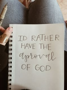 someone holding a note that says i'd rather have the approval of god