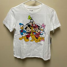 Disney T-Shirt New With Tags Size Small Jr Sizing Crop Sits At Waist All Characters On Front With Names On The Back Last Pic Shows A Tiny Tag Like Hole In The Back Neck Line. Playful Cartoon Print T-shirt For Disney Trips, Trendy T-shirt With Character Print For Disney Fan Events, Casual Multicolor T-shirt For Disney Trips, Multicolor Cotton T-shirt For Disney Trips, Spring Mickey Mouse Crew Neck T-shirt, Disney T-shirt For Fan Events In Spring, Cute White Tops For Disney Trips, Casual Mickey Mouse T-shirt For Spring, Disney Character Print Tops For Disney Trips