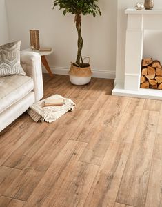 a living room with wood flooring and a tree in the middle of the room