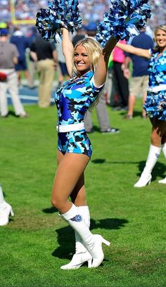 the cheerleaders are dressed in blue and white