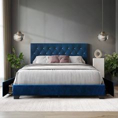 a bed with blue upholstered headboard in a bedroom