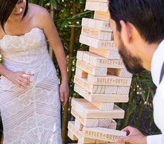 a bride and groom playing with wooden blocks