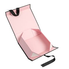 an open pink box with a black ribbon on the bottom and inside, sitting in front of a white background