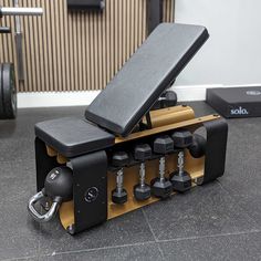 an exercise bench with dumbs on it