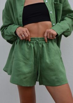 Discover our effortlessly chic forest green linen shorts. Crafted from premium European linen, these shorts offer exceptional softness and comfort. Perfect for a day at the beach, a casual city outing, or relaxed weekend wear. Featuring a wide leg, convenient side pockets, and a comfortable elastic waistband, they're designed to elevate your summer wardrobe. We prioritize quality and sustainability.  Our linen is OEKO-TEX Standard 100 certified, meaning it's free from harmful chemicals. DETAILS:  - Wide Linen Shorts - Loose Fit  - Two side Pockets - Elastic Band  - European Softened Linen  - Handmade in our small studio in Siauliai SIZE IN THE PICTURE:  The model in our photos is wearing a size S. The Model's height is 5'5"/ 165cm. SIZE CHART:  *Please note that this chart indicates garmen Casual Green Shorts For Summer, Relaxed Solid Shorts For Summer, Relaxed Summer Shorts, Solid Color High-waisted Pajama Shorts For Spring, Relaxed Solid Color Summer Shorts, Beach Shorts With Elastic Waistband In Green, Green Summer Pajama Shorts With Elastic Waistband, Green Summer Shorts For Day Out, Green Shorts For Summer Day Out