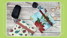 two small purses sitting next to each other on top of a wooden table with coins