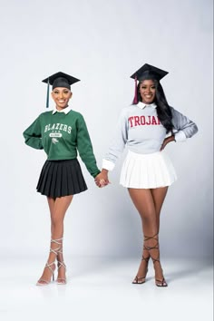 two women in cheerleader outfits holding hands