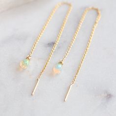 sweet, modern + delicate. These natural, Australian Opal briolettes add the perfect pop of color + sparkle to this sleek, modern thread-style earring. Chain threads directly through piercing. Earring Specifications: yellow gold filled threader chain measures 4" long opals measure 6 x 4mm + are wire wrapped to attach Thread Earrings Gold, Gold Thread Earrings, Earring Chain, Thread Earrings, Australian Opal, Earrings Gold, Wire Wrapped, Gold Earrings, Gold Filled