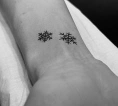 two small snowflakes on the wrist