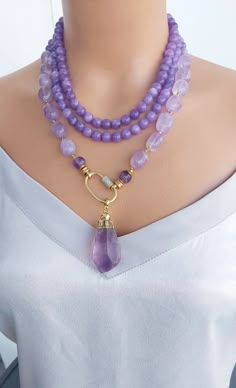 📍 Description :  The handmade 3 strand necklace has been designed with Amethyst  gemstone in purple colour 💎 Pendant : A raw Amethyst stone with gold frame 💥 The colours of the stone may differ slightly in photo shoots caused by lighting and reflections. The necklace is Modern chunky statement gemstone beaded asymetrical necklace for women. The necklace does not stretch and well kept its shape. ✂ Materials : The natural stone used are; Amethyst gemstone The chain and gold-colored materials used are 14 carat gold plated on brass and do not tarnish. 📐 Dimensions : It has a length of 64 centimeters/26 inç and can be adjusted using an extention cord. The weight of the necklace is 148 gr. 🧹 Care of the necklace: Although my products are durable and unlikely to tarnish, it is better to avoi Pretty Jewellery Necklace, Chunky Bead Necklaces, Purple Colour, Stone Beaded Necklace, Raw Amethyst, Unique Jewelry Designs, Amethyst Beads, Chunky Necklace, Bracelet Crafts