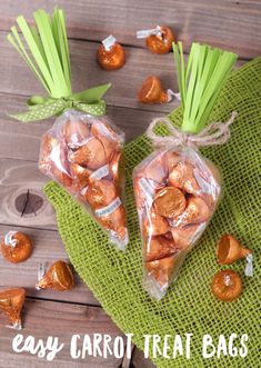 two bags filled with candy sitting on top of a green cloth next to other candies