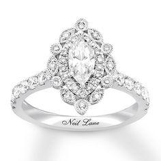 a white gold engagement ring with an oval cut diamond surrounded by small round brilliant diamonds