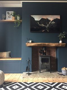 a living room with blue walls and a wood burning stove