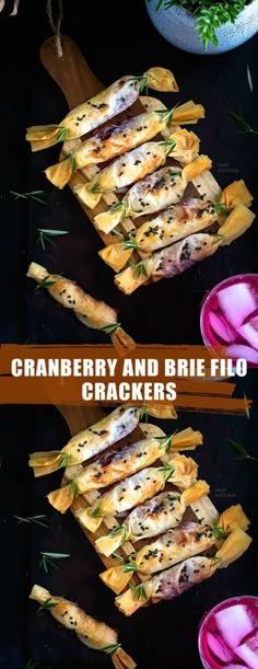 cranberry and brie filo crackers on a black surface with herbs