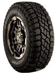 an all terrain tire on a white background