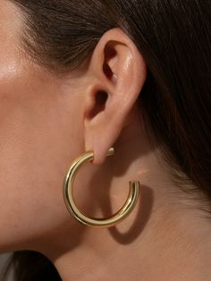 Nothing is more classic than a pair of Effortless Tube Hoop Earrings. Coming in gold and silver, these hoop earrings are sure to go with everything in your closet and your jewelry collection. For a unique look, we made a special backing that looks like the hoop is continuing even behind your ear. Create an ear stack by pairing these tube hoops with any of our hoops and huggies. Tube Hoop Earrings, Ear Stack, Earrings In Gold, Beauty Items, Gold And Silver, Gold Earrings, Jewelry Box, Jewelry Collection, That Look