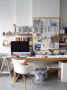 a desk with two chairs and a computer monitor on top of it in an office