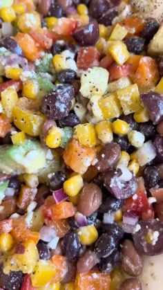 a close up of a plate of food with beans and corn