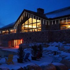 a large house with lights on the roof and windows