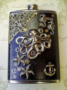 an intricately decorated flask with an octopus and anchors on the side, sits on a table