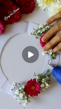 a woman's hands on top of a white plate with flowers