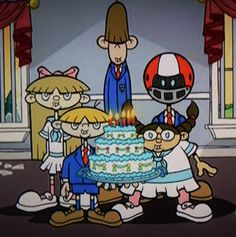 cartoon characters standing around a birthday cake with lit candles