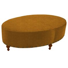 a round ottoman sitting on top of a wooden table