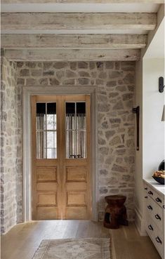 an entry way with two doors and a rug on the floor