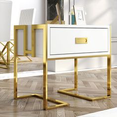 a white and gold desk with two chairs next to it in a room that has hardwood floors