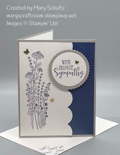 a card with some flowers on it and the words sympathy written in blue ink, is displayed