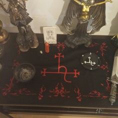 a table topped with statues and candles on top of it