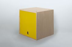 a yellow cabinet with the door open on a gray background, it appears to be made from plywood