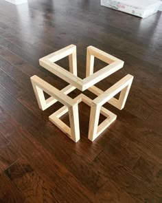 a wooden sculpture sitting on top of a hard wood floor