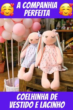 two stuffed animals sitting next to each other on top of a wooden table with balloons in the background