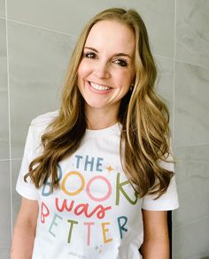 a woman with long hair wearing a t - shirt that says the book was better