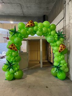 an arch made out of green balloons with ladybugs on them and stars in the middle