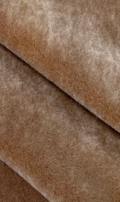 a close up view of a tan colored material with very thin fur on it's edges