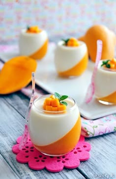 small desserts are arranged on trays with pink doily