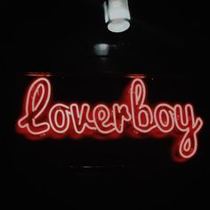 a neon sign that reads loverboy on it's side in the dark,