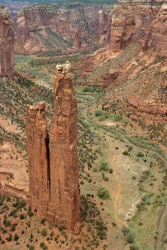 an aerial view of canyons, rocks and trees in the desert with water running through them