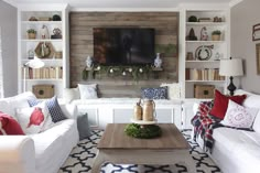 a living room filled with furniture and a flat screen tv mounted to the side of a wall