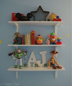 two white shelves with toys and letters on them